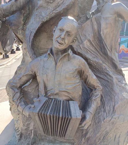 Closeup of part of a statue on the corner of George Street - party central for downtown St Johns