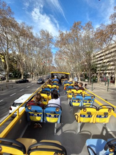 On the top deck of a hop on / hop off tour bus in Lisbon Portugal.