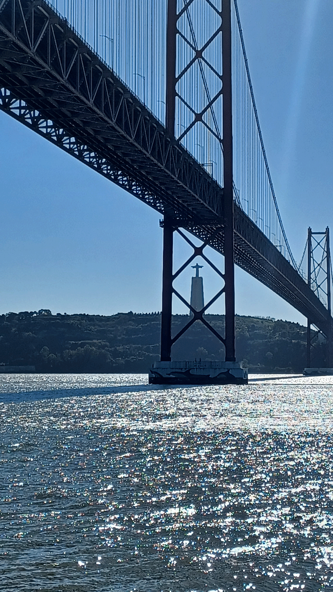 The Redeemer statue across the 25th September Bridge in Lisbon